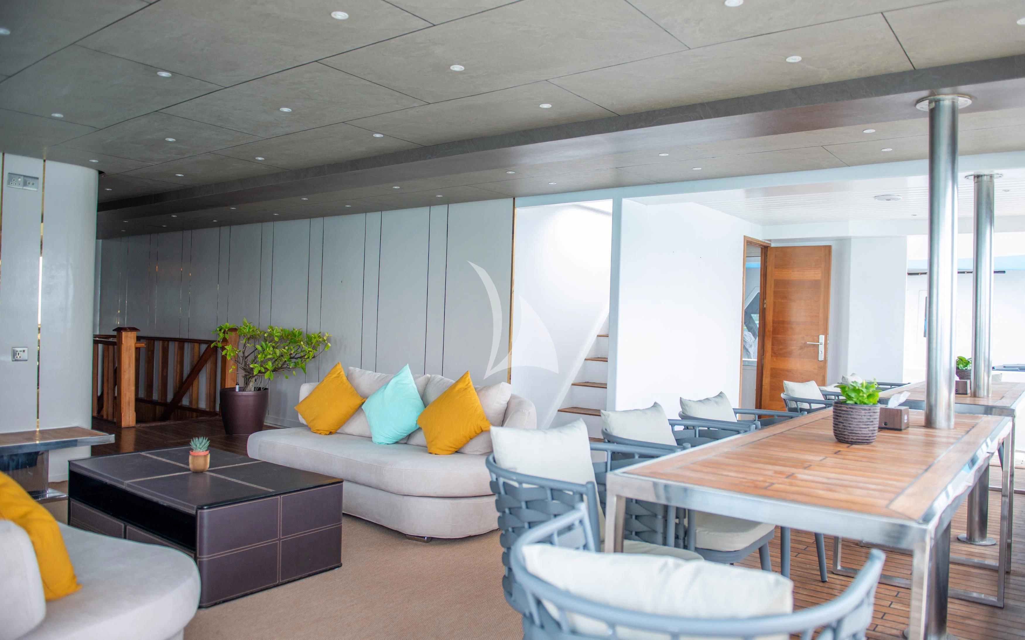a room with a couch and a table and chairs aboard ARK NOBLE Yacht for Sale