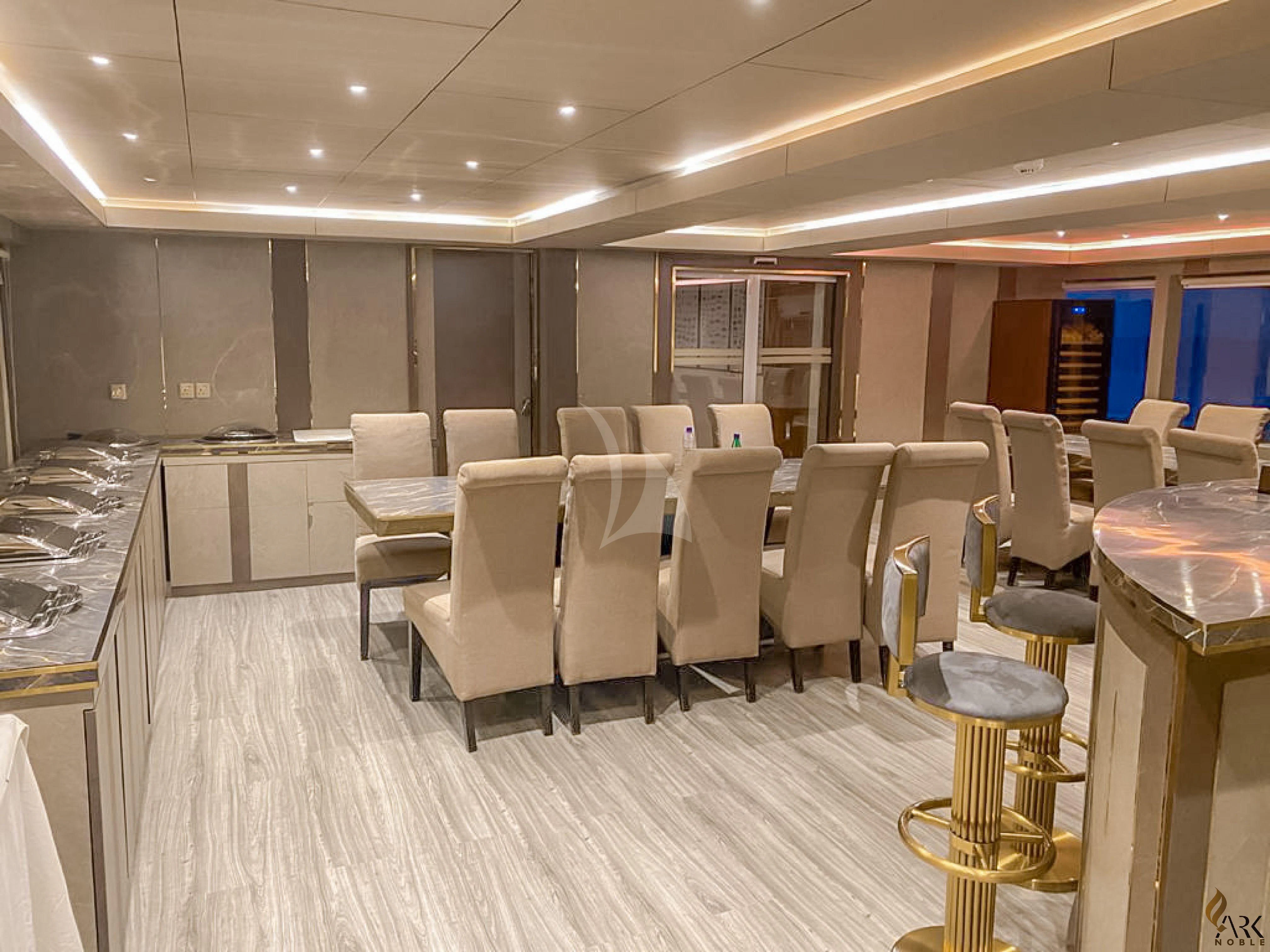 a room with tables and chairs aboard ARK NOBLE Yacht for Sale