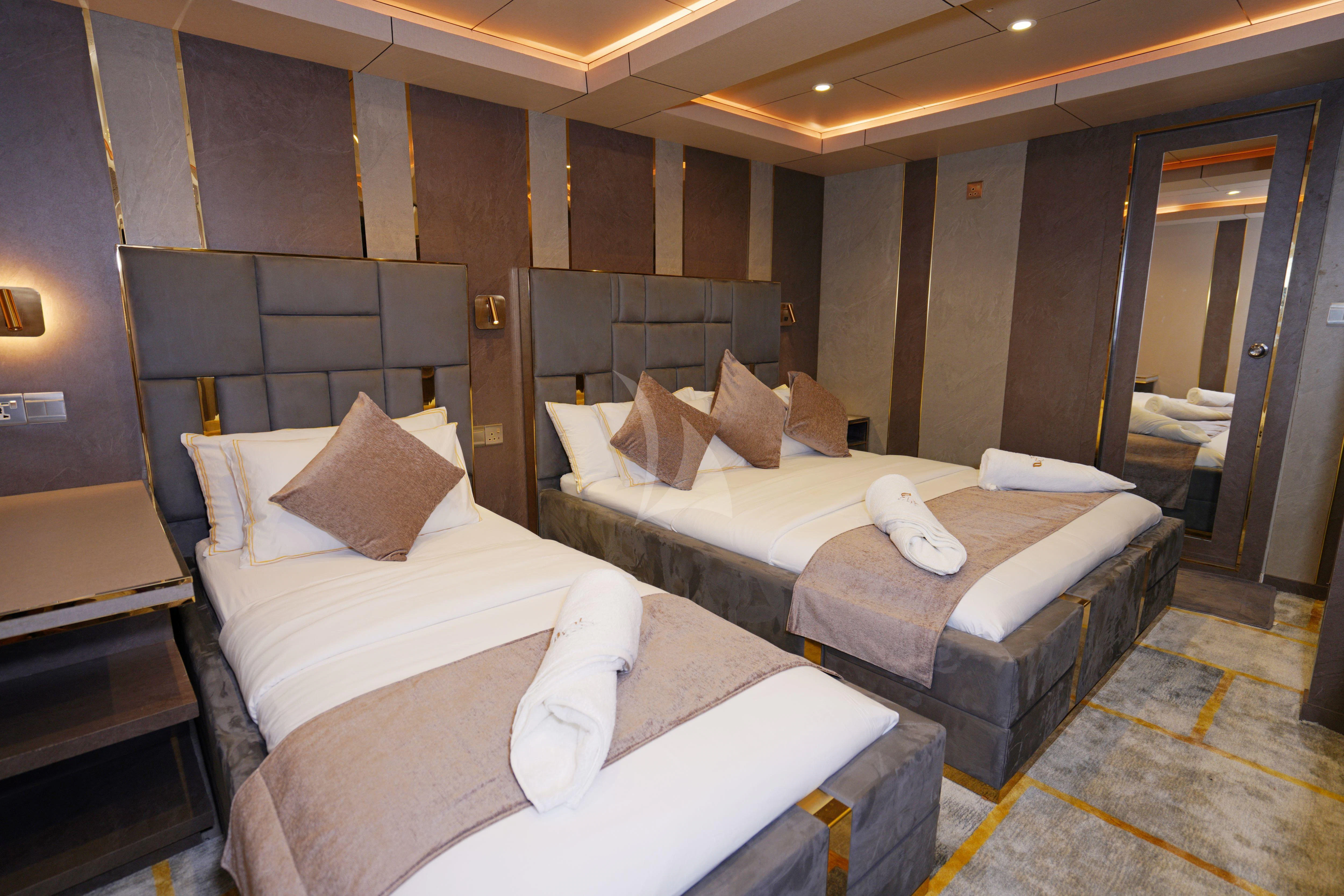 a room with beds and a door aboard ARK NOBLE Yacht for Sale