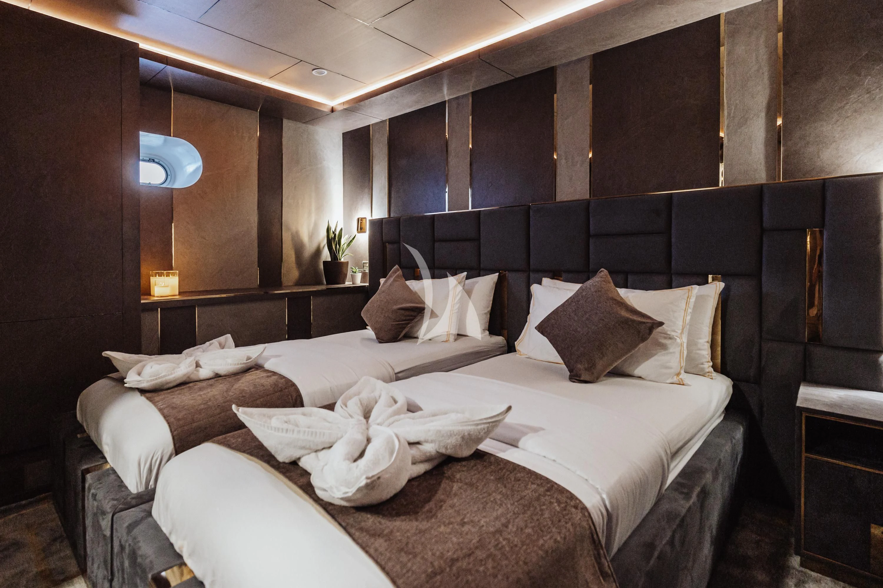 a room with a bed and a table aboard ARK NOBLE Yacht for Sale