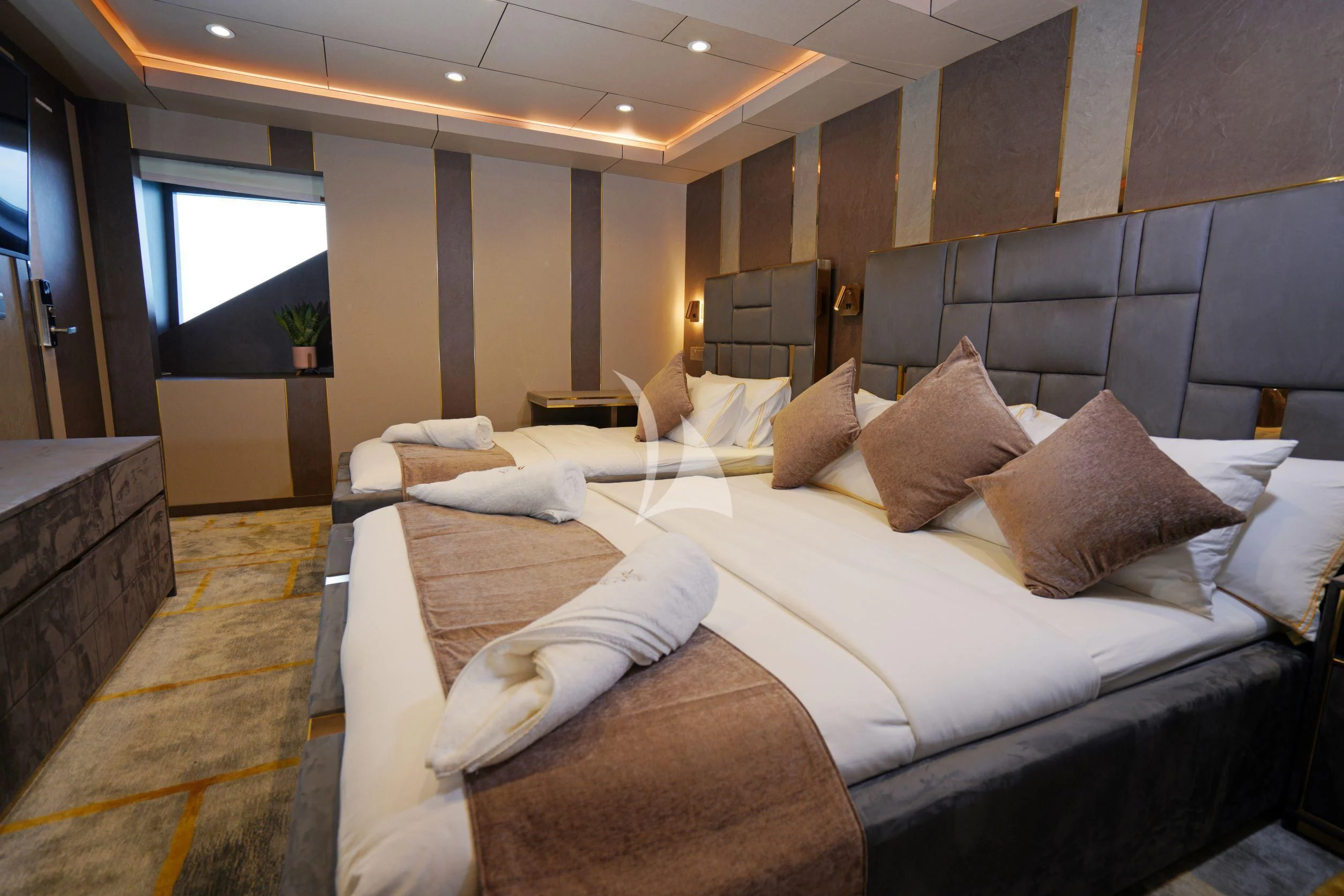 a room with a bed and a couch aboard ARK NOBLE Yacht for Sale