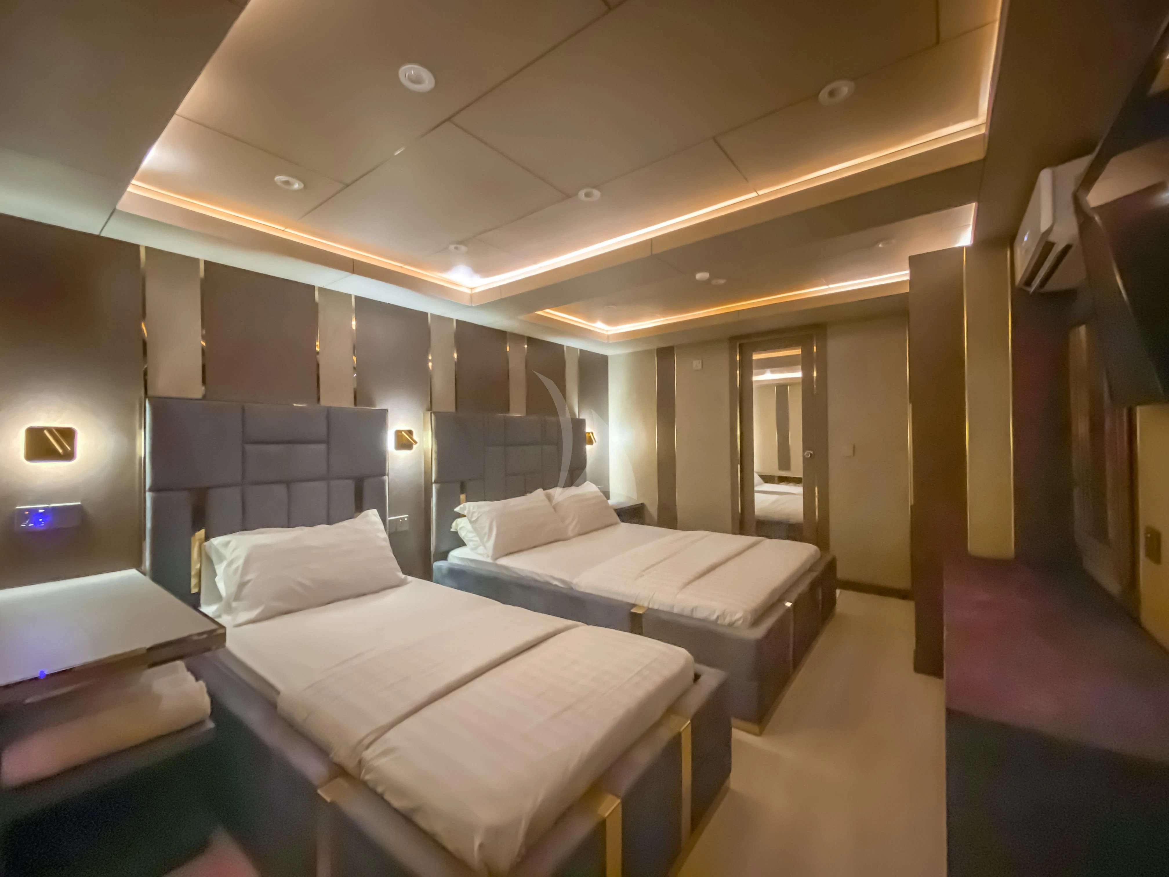 a room with beds and a window aboard ARK NOBLE Yacht for Sale