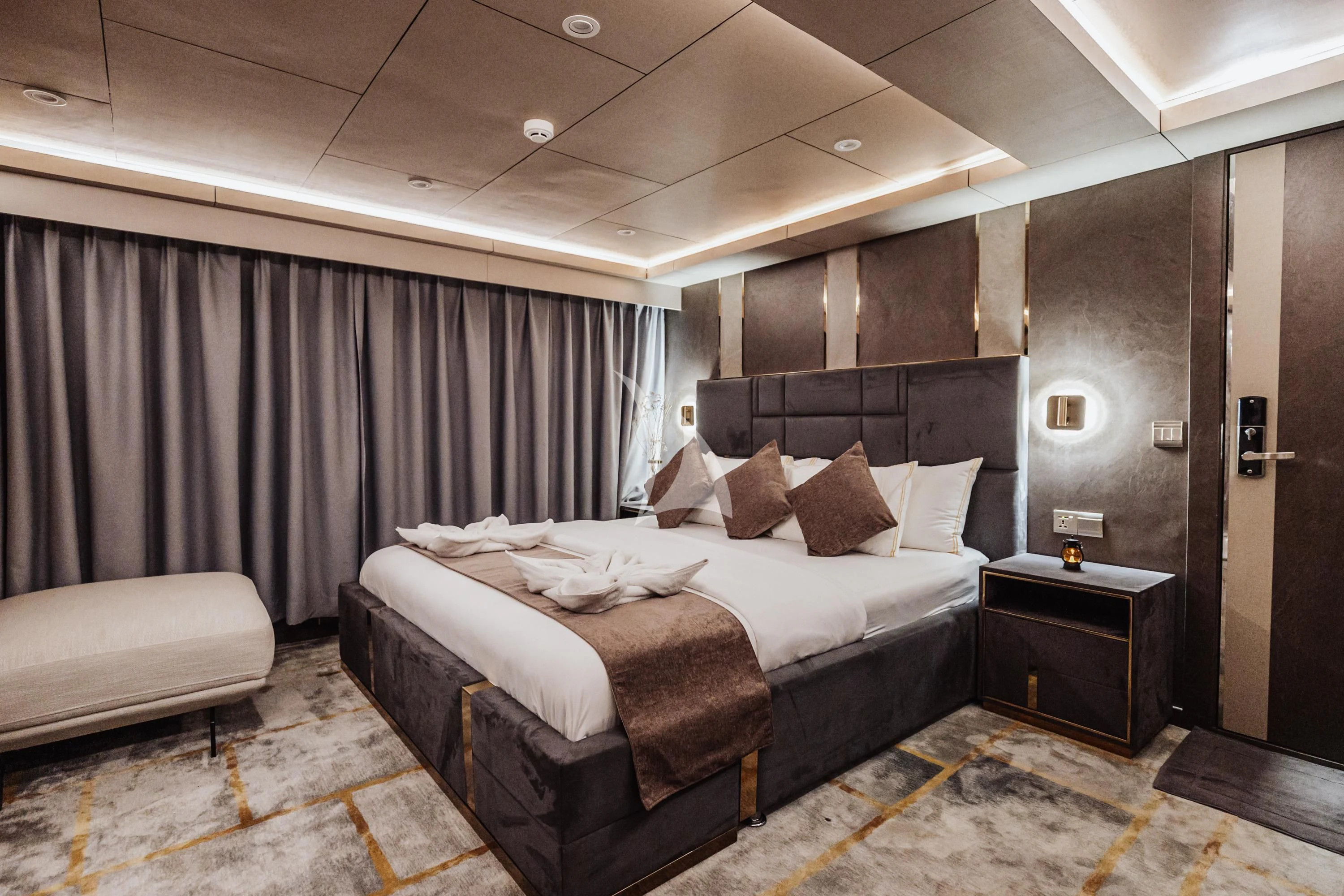 a bedroom with a bed and a desk aboard ARK NOBLE Yacht for Sale