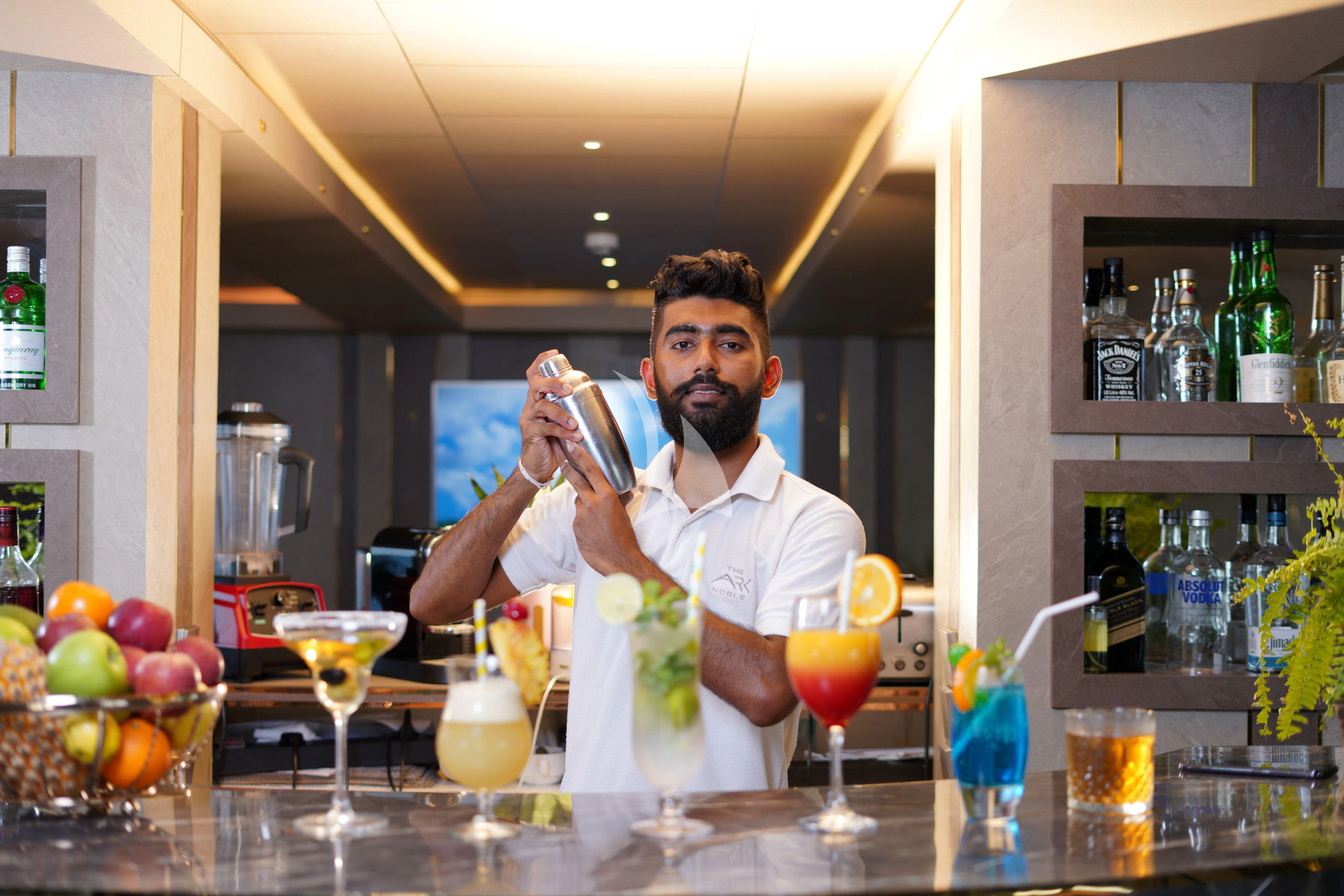 a person holding a glass of wine aboard ARK NOBLE Yacht for Sale