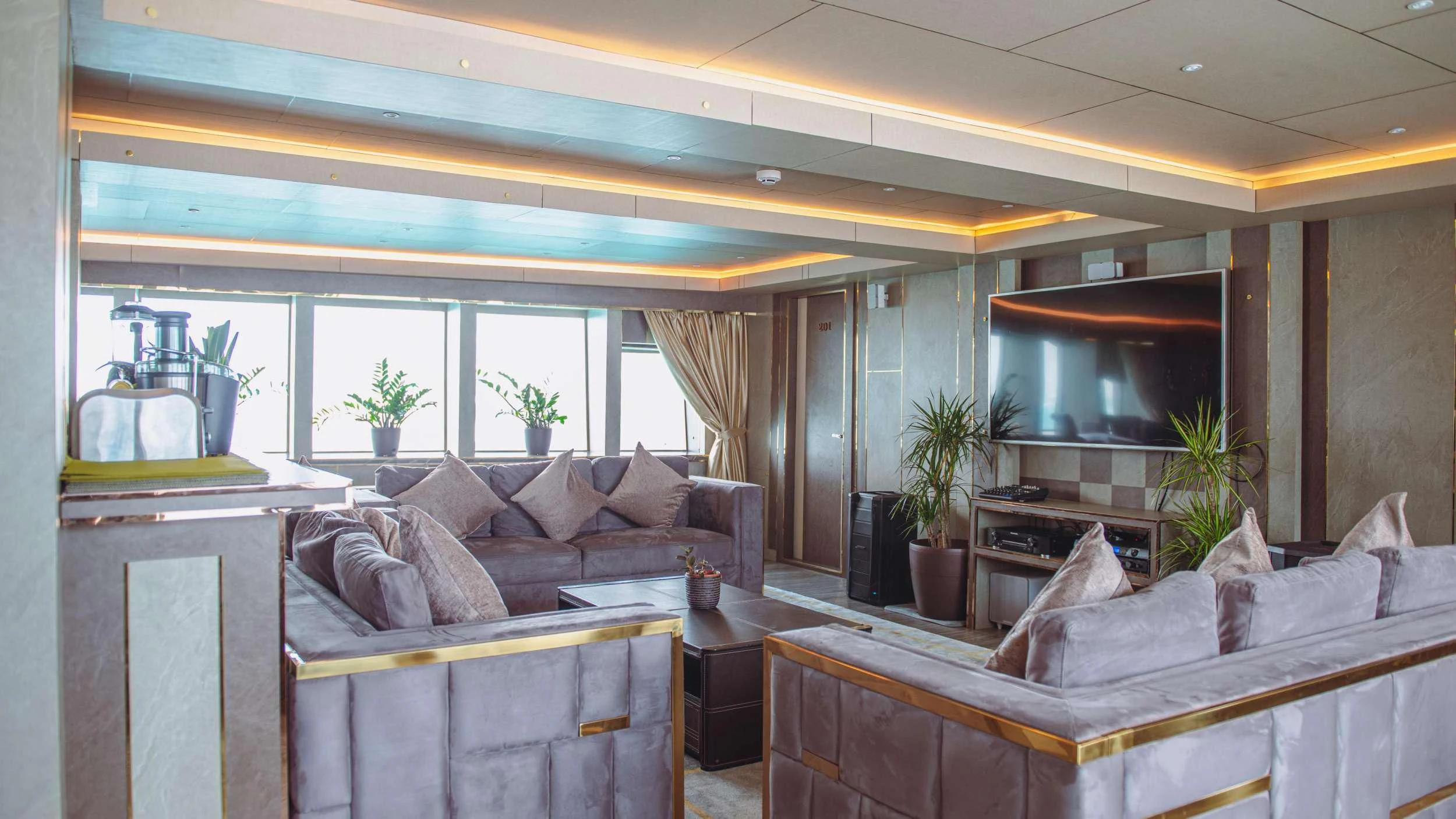 a living room with a couch and a fireplace aboard ARK NOBLE Yacht for Sale