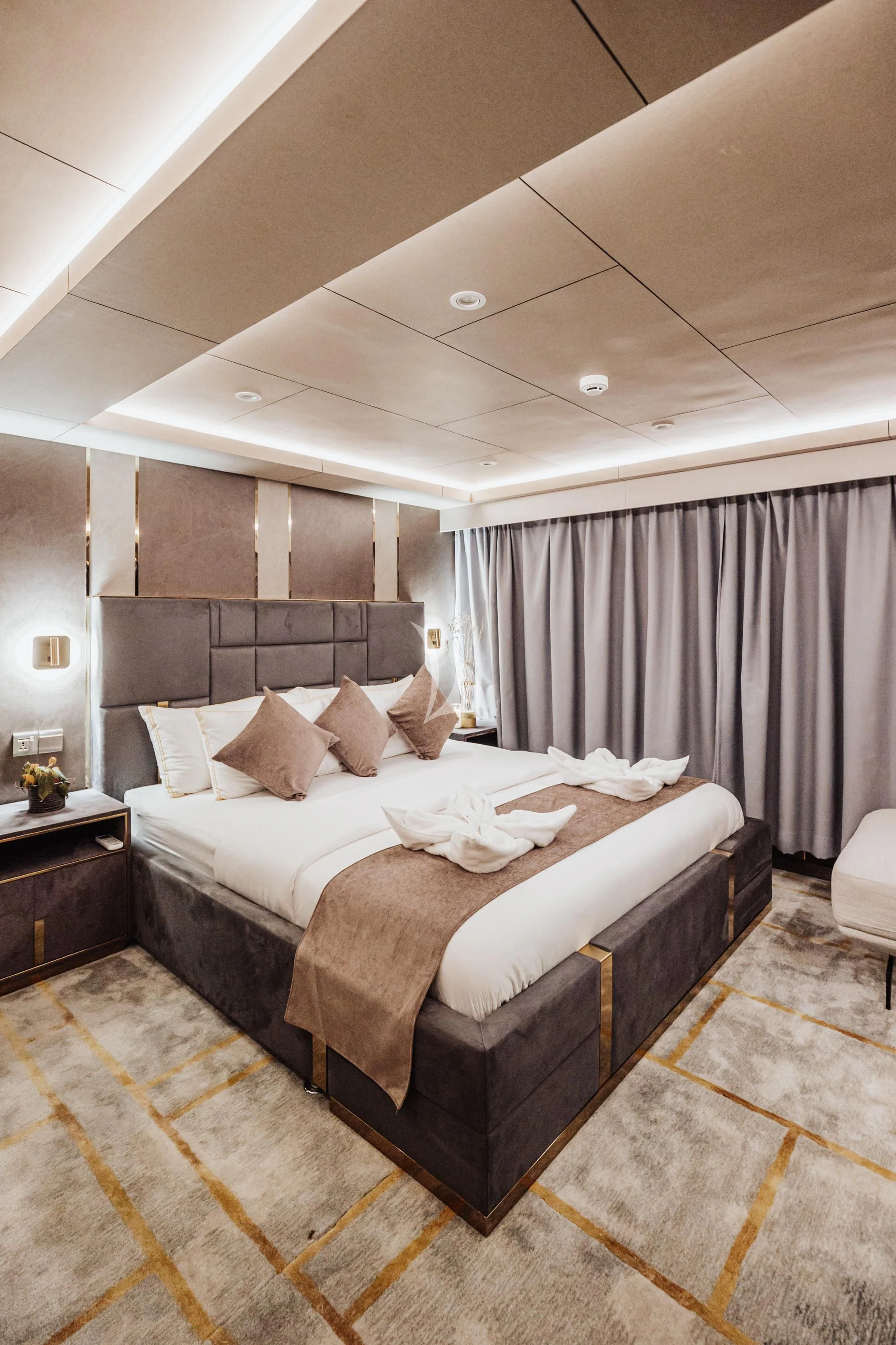 a bed with a white sheet and pillows aboard ARK NOBLE Yacht for Sale