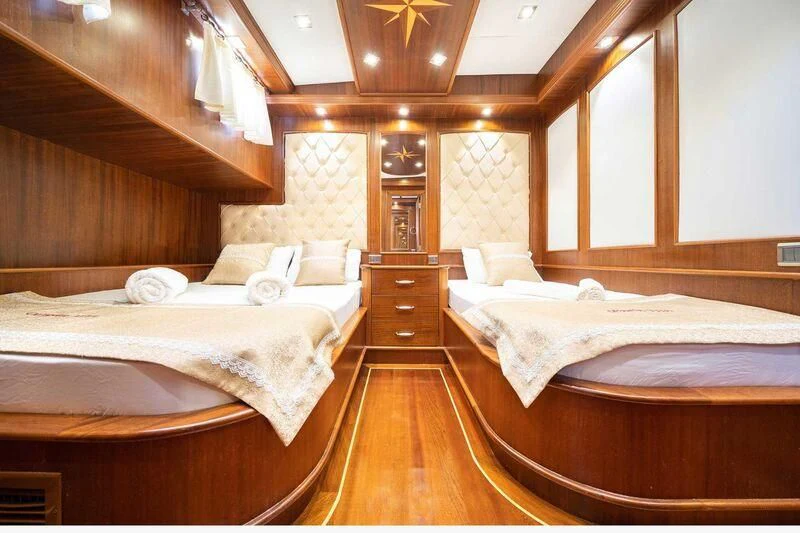 a room with a few beds aboard QUESTA VITA Yacht for Sale