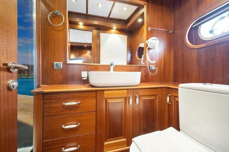 a bathroom with a sink and a bathtub aboard QUESTA VITA Yacht for Sale