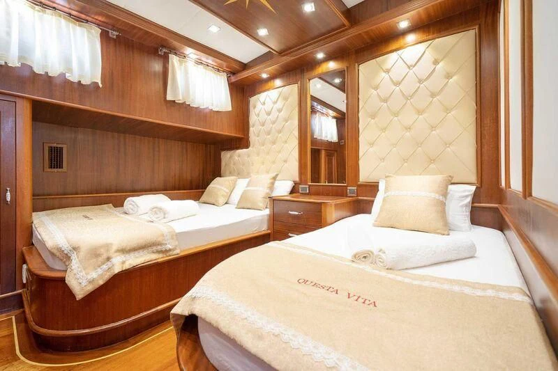 a room with a couple of beds aboard QUESTA VITA Yacht for Sale
