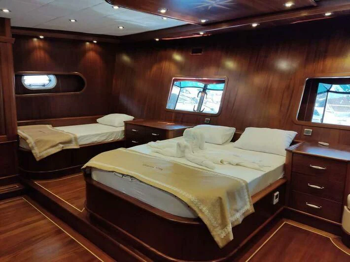 a room with a bed and a tv aboard QUESTA VITA Yacht for Sale