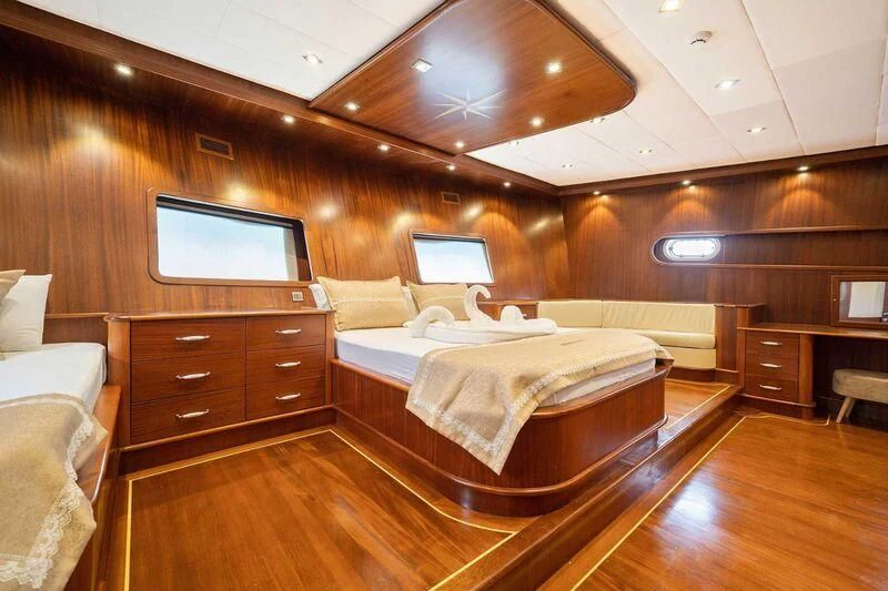 a room with a bed and a tv aboard QUESTA VITA Yacht for Sale