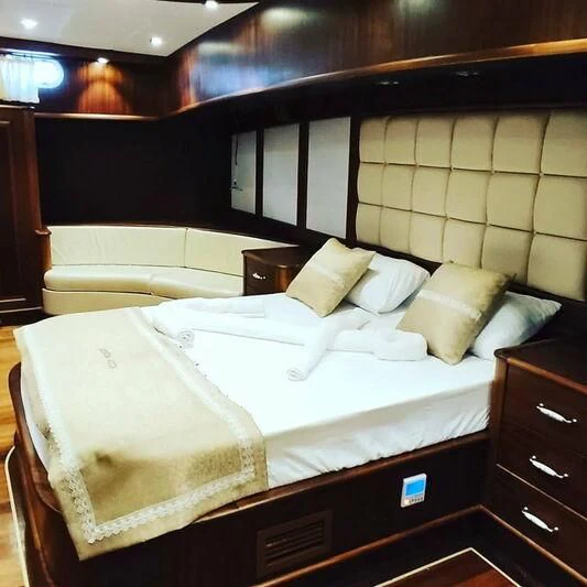 a room with two beds aboard QUESTA VITA Yacht for Sale