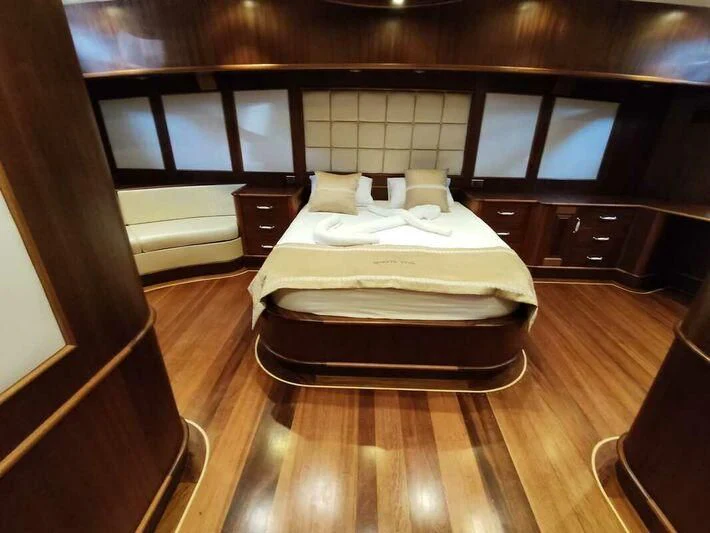 a bed in a room aboard QUESTA VITA Yacht for Sale
