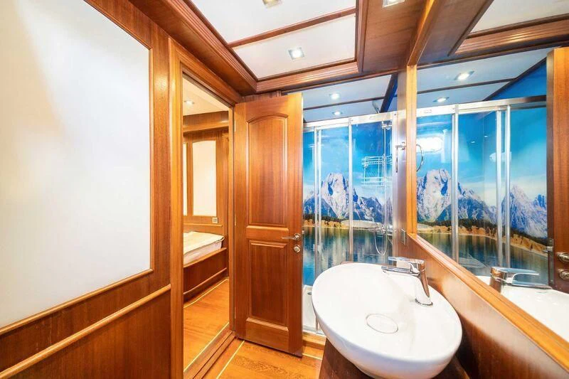 a bathroom with a sink and a mirror aboard QUESTA VITA Yacht for Sale