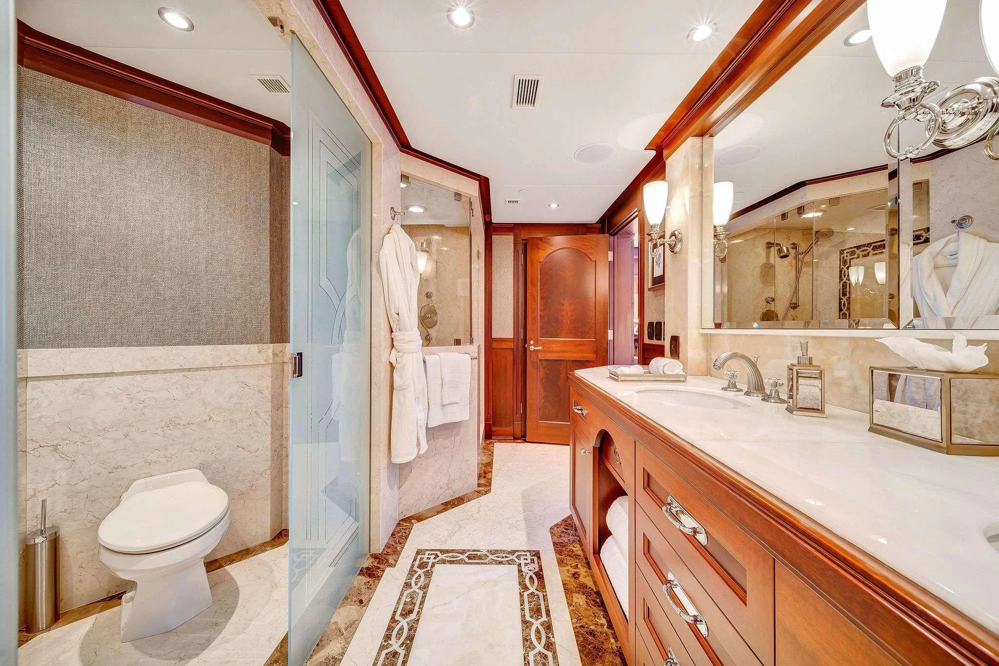 a bathroom with a sink toilet and a mirror aboard VALHALLA Yacht for Sale