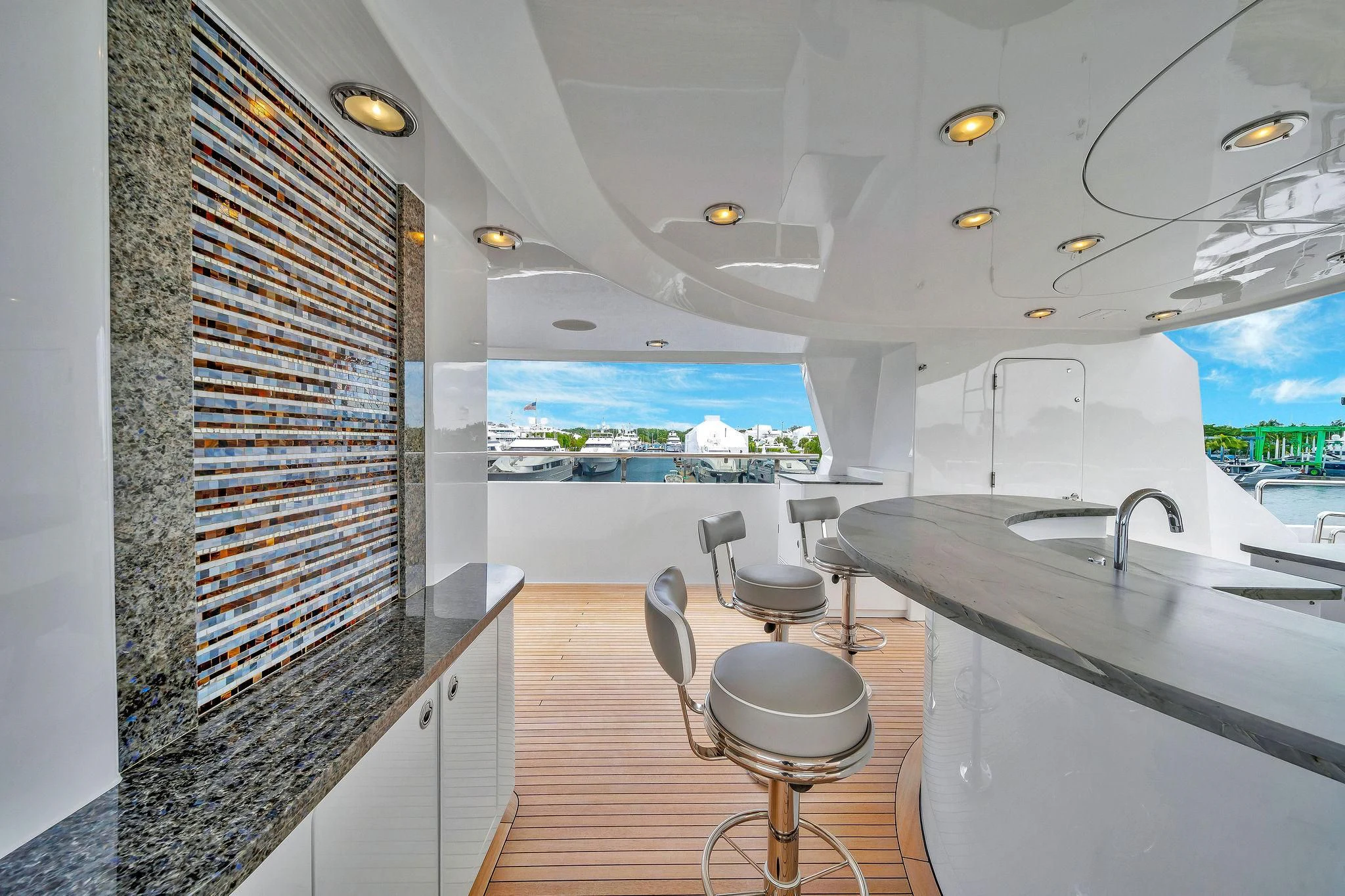 a room with a large window and a table with chairs and a view of the water aboard VALHALLA Yacht for Sale