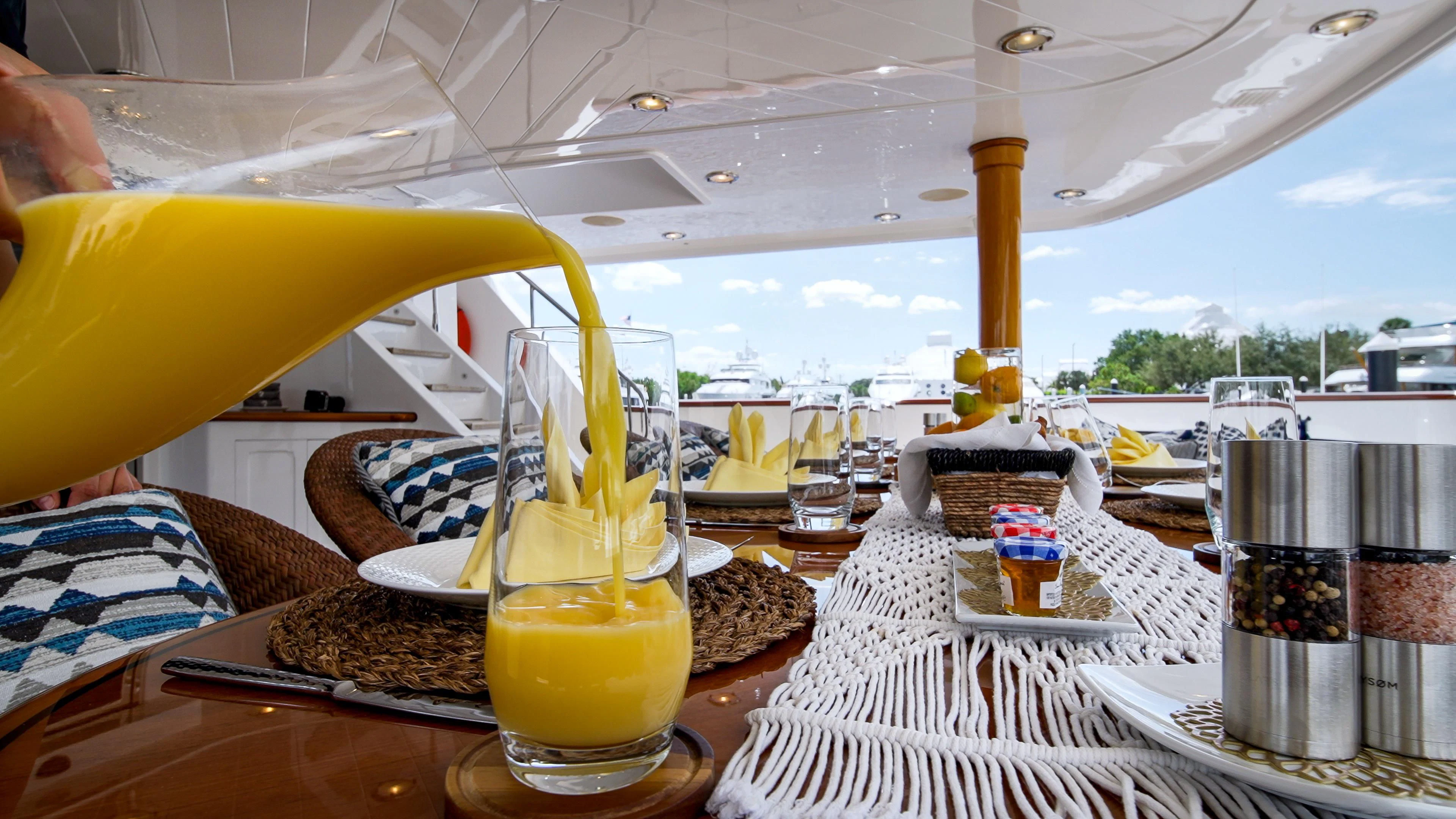 a person pouring a drink into a glass aboard VALHALLA Yacht for Sale