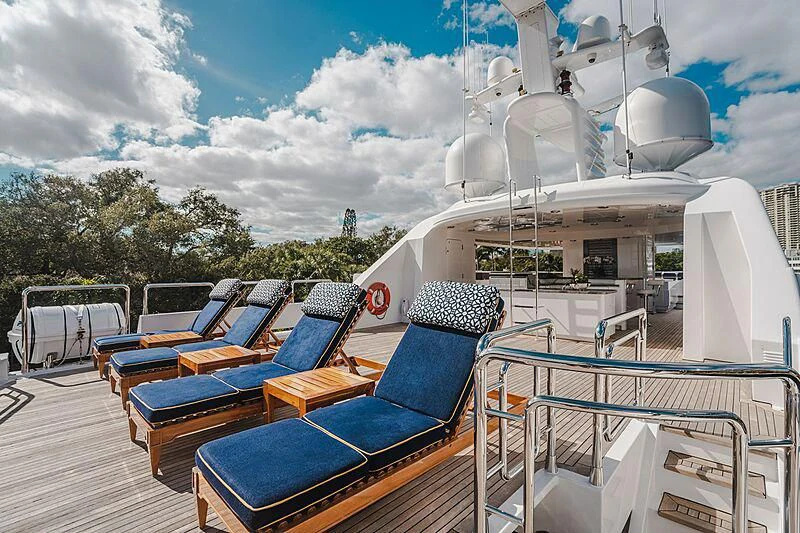 a deck with chairs and tables aboard VALHALLA Yacht for Sale