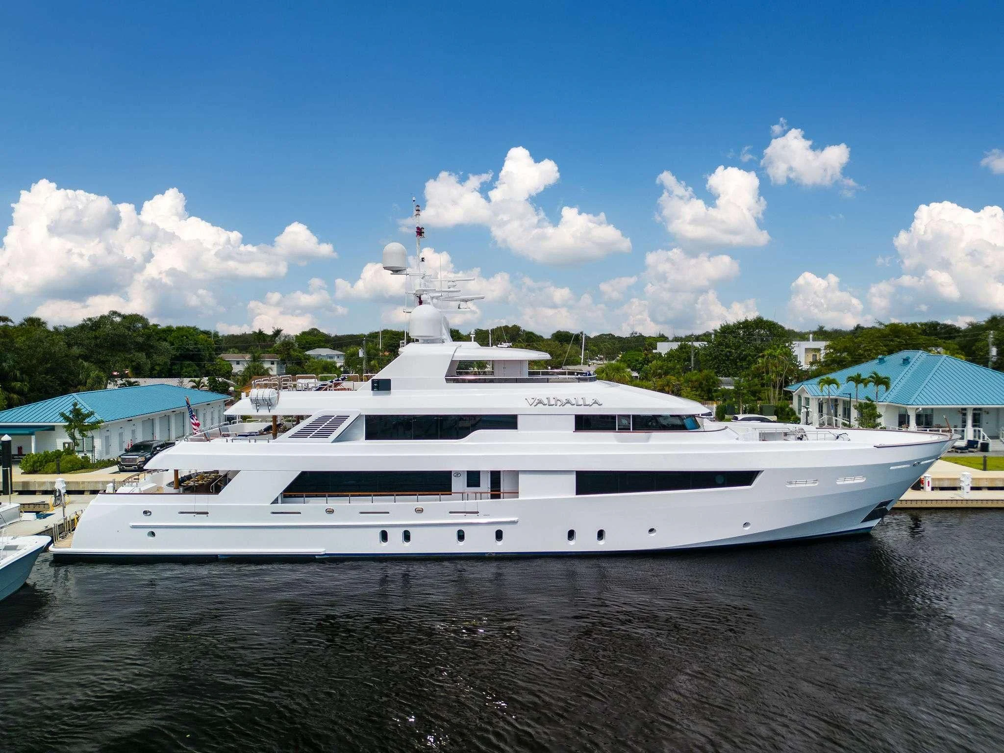 a white yacht in a harbor aboard VALHALLA Yacht for Sale