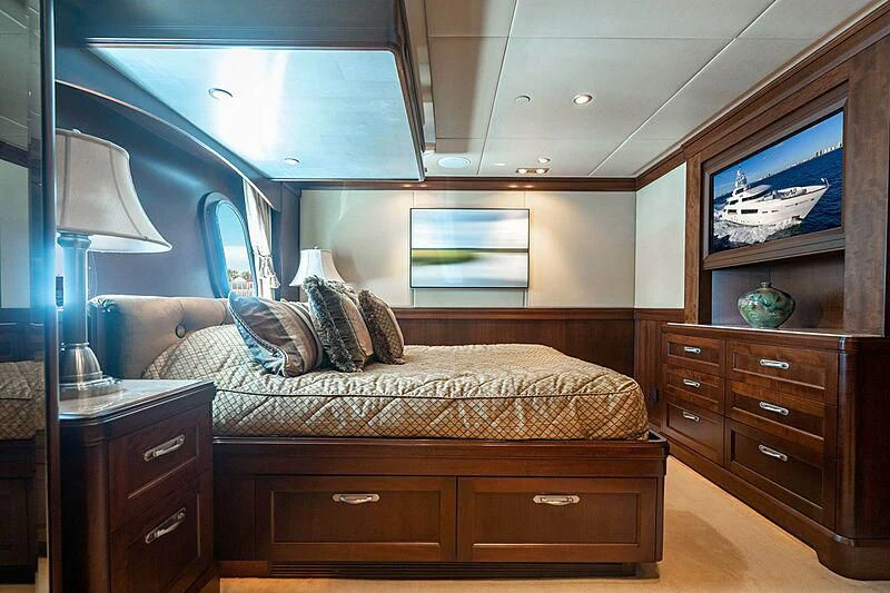 a bedroom with a bed and a television aboard VALHALLA Yacht for Sale