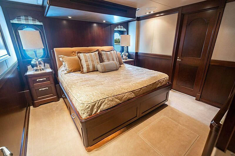 a bedroom with a bed and a desk aboard VALHALLA Yacht for Sale