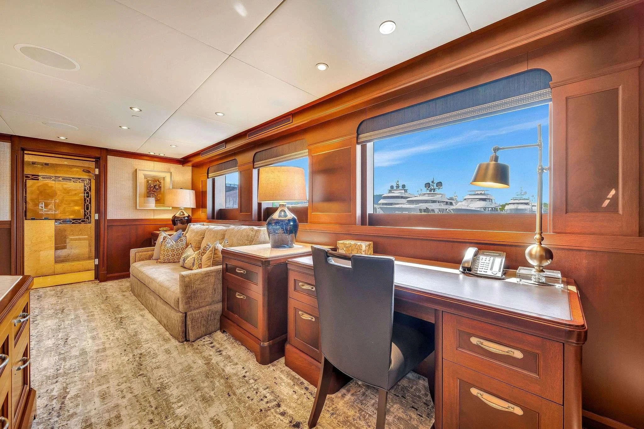 a living room with a tv and a desk aboard VALHALLA Yacht for Sale