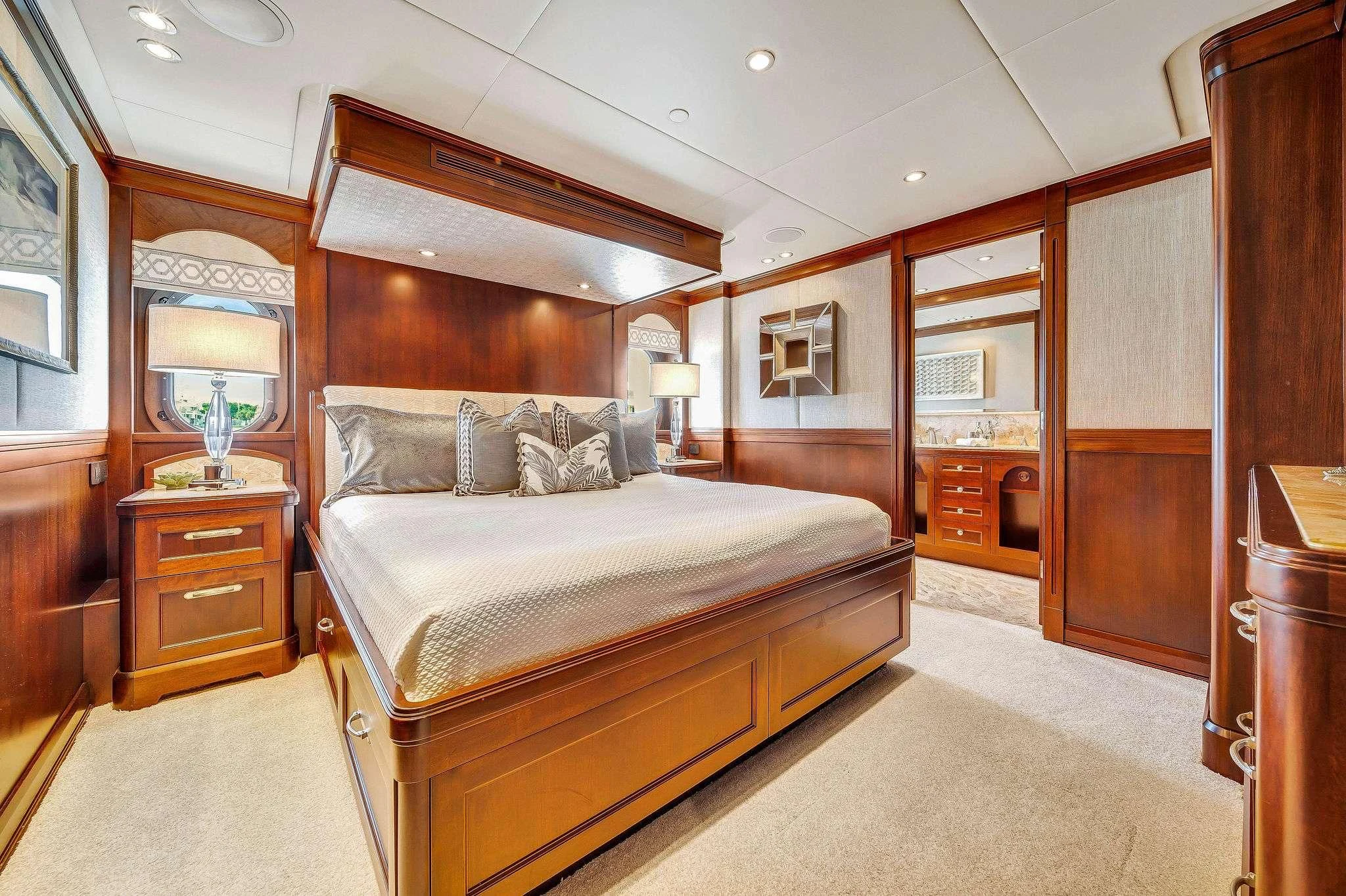 a bedroom with a bed and a mirror aboard VALHALLA Yacht for Sale