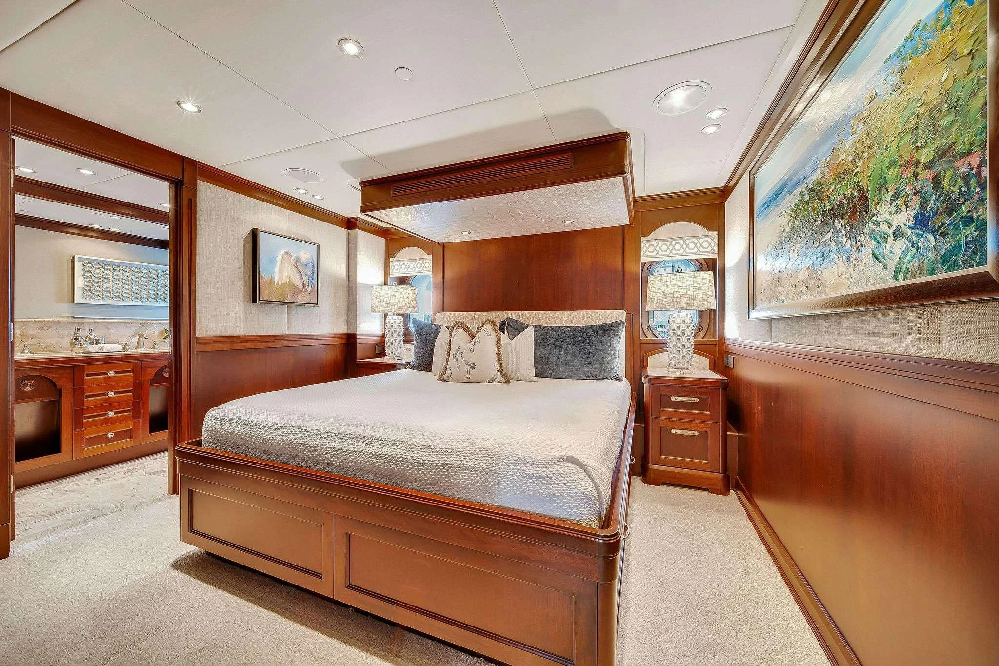 a bedroom with a bed and a desk aboard VALHALLA Yacht for Sale