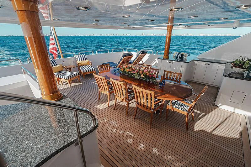a deck with chairs and tables on it aboard VALHALLA Yacht for Sale