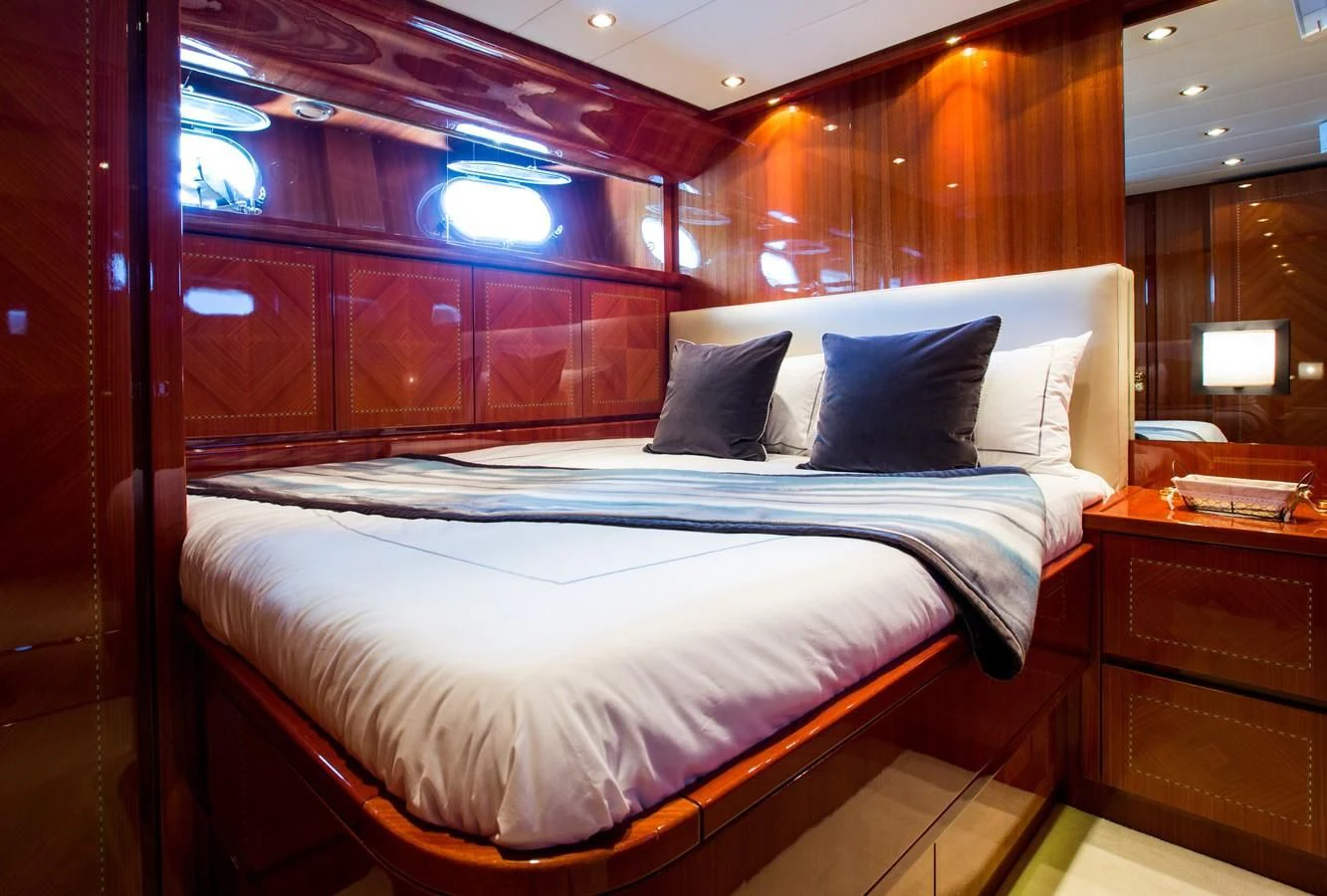 a bed with a blue and white bed spread aboard KIDI ONE Yacht for Sale