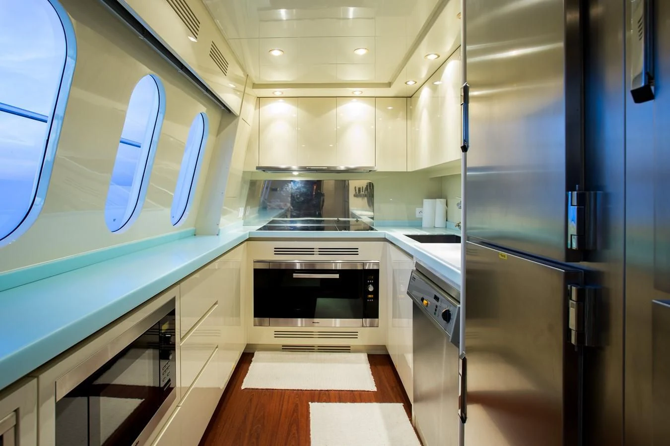 a kitchen with a stainless steel refrigerator aboard KIDI ONE Yacht for Sale