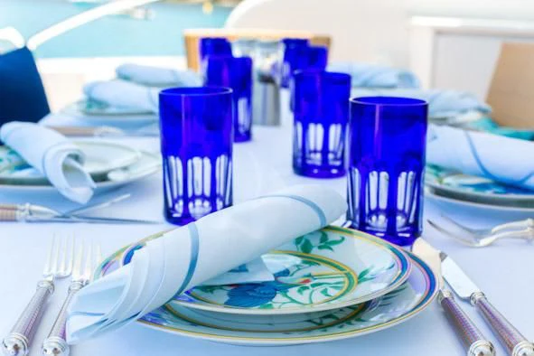 a table with a plate and glasses aboard KIDI ONE Yacht for Sale