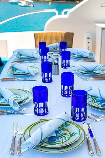 a table with plates and cups aboard KIDI ONE Yacht for Sale