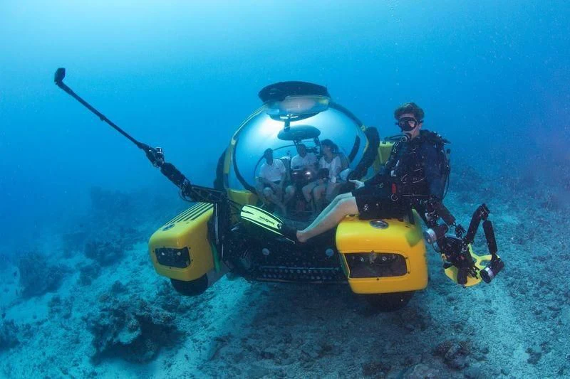 a person on a yellow and black motorcycle in the water aboard AD-VANTAGE Yacht for Sale
