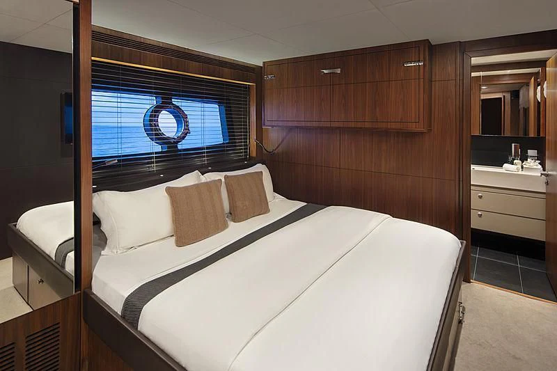 a bed with white sheets aboard BRAVA Yacht for Sale