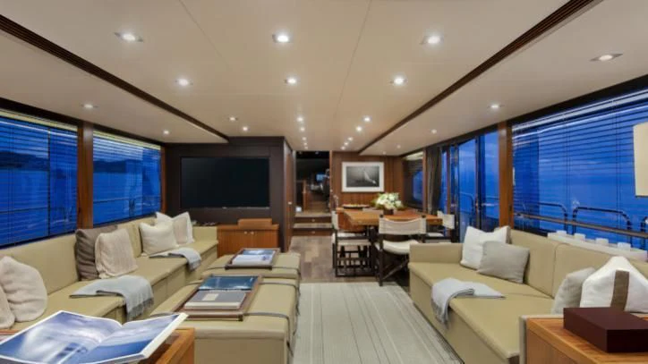 a living room with a large screen aboard BRAVA Yacht for Sale