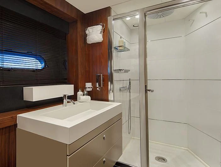 a bathroom with a shower unit and sink aboard BRAVA Yacht for Sale