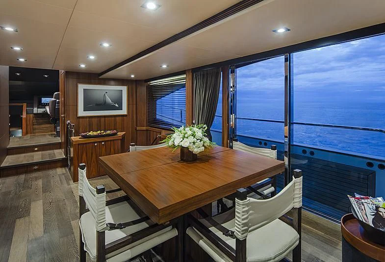 a dining table in a room aboard BRAVA Yacht for Sale