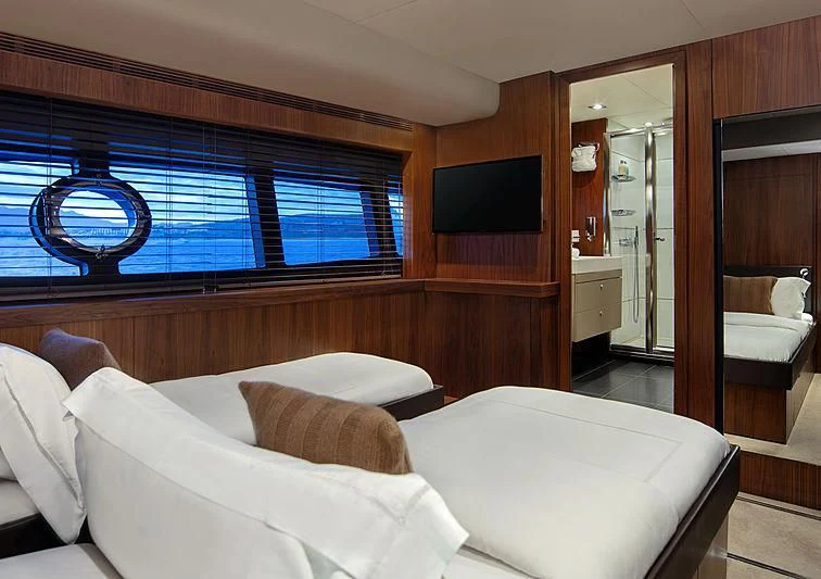a room with a bed and a window aboard BRAVA Yacht for Sale