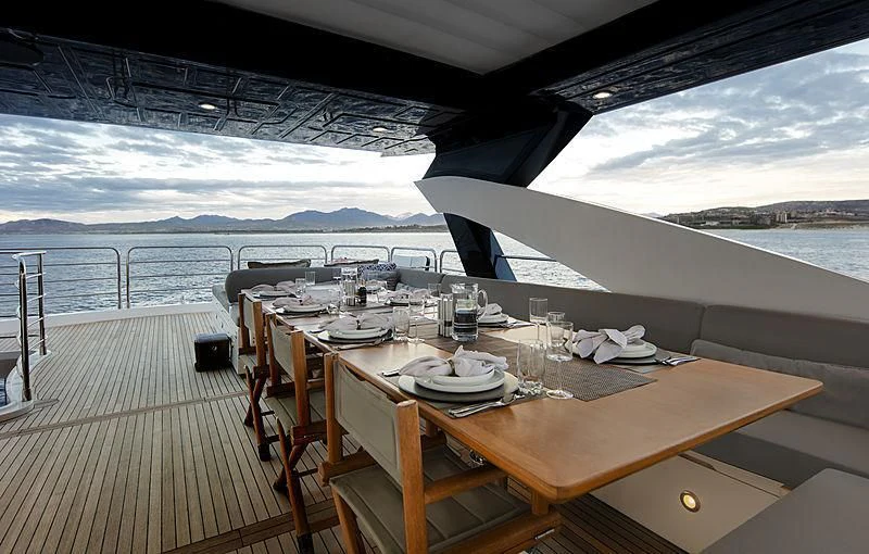 a table set for a meal on a boat aboard BRAVA Yacht for Sale