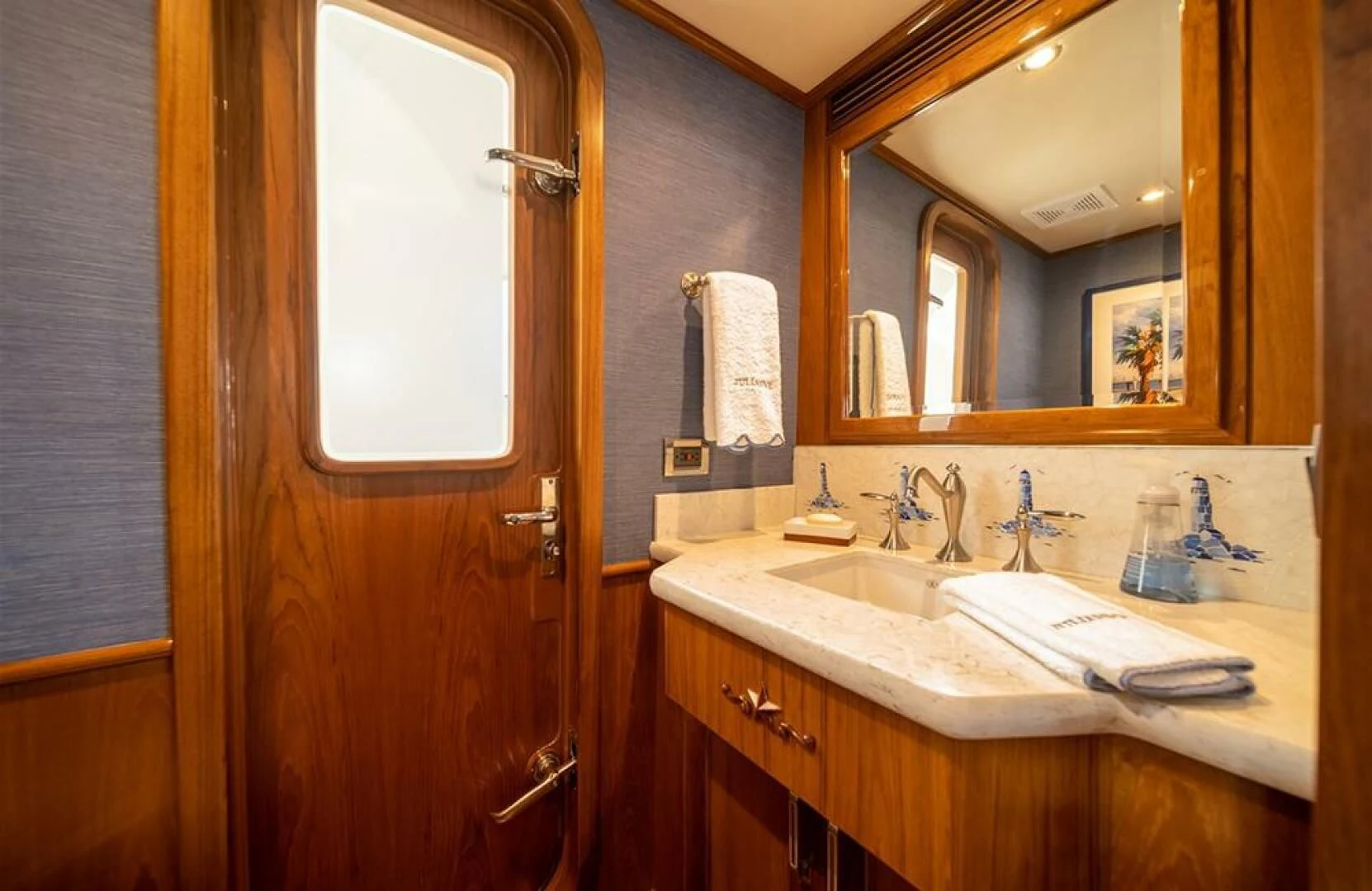 a bathroom with a sink and a mirror aboard JULIANNE Yacht for Sale