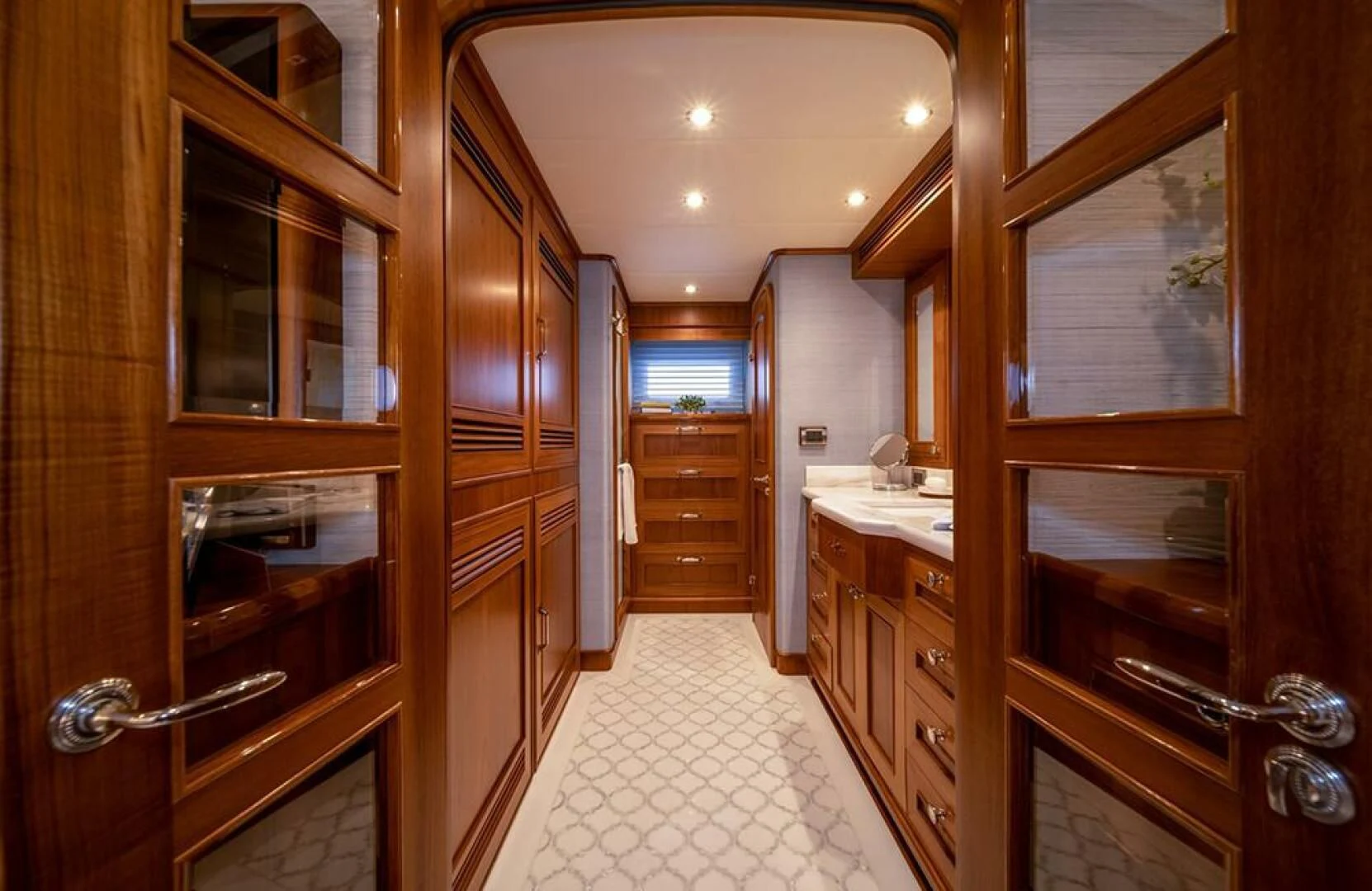 a bathroom with wooden cabinets aboard JULIANNE Yacht for Sale