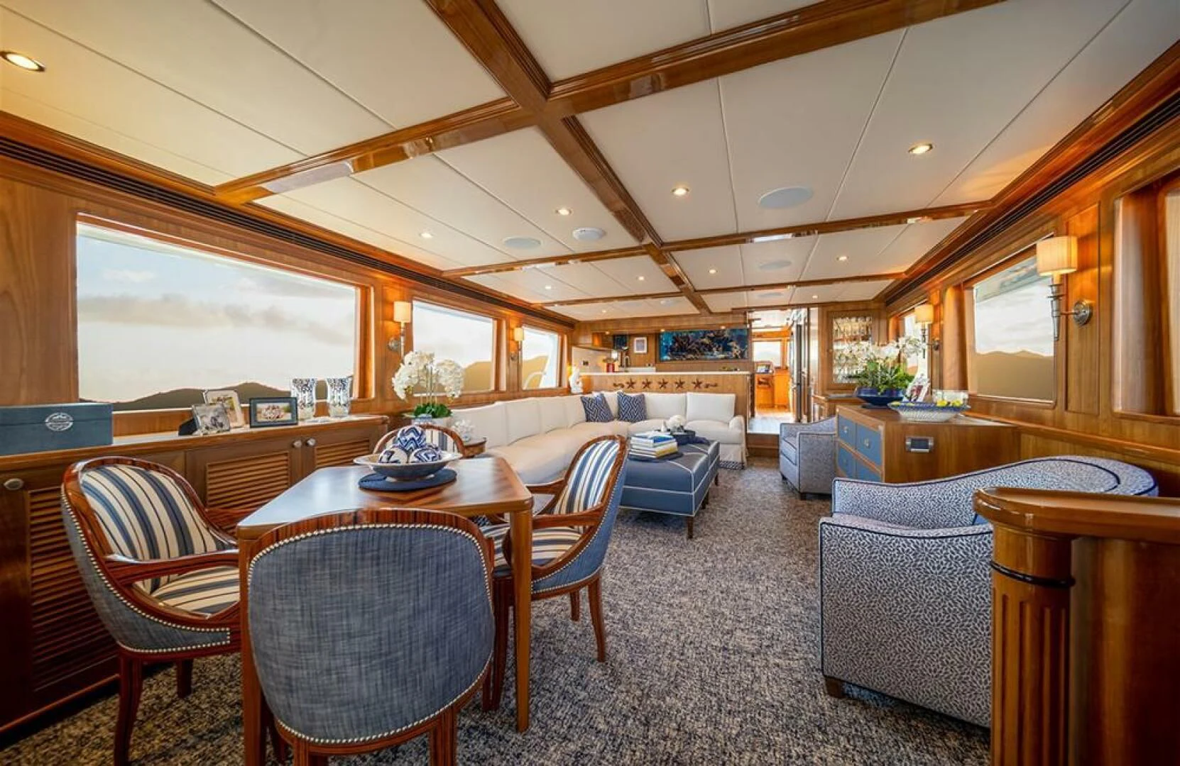 a large living room with a table and chairs aboard JULIANNE Yacht for Sale