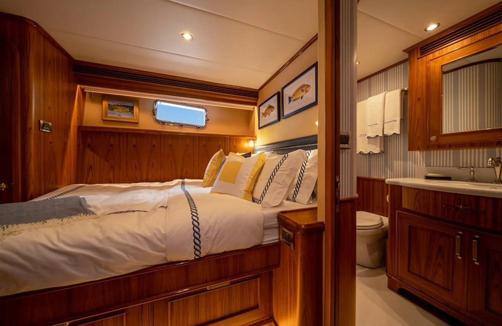 a bedroom with a bed and a mirror aboard JULIANNE Yacht for Sale