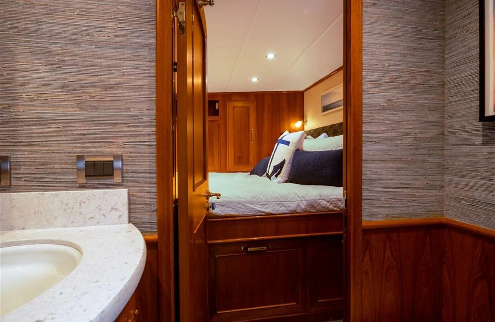 a bedroom with a bed and a sink aboard JULIANNE Yacht for Sale