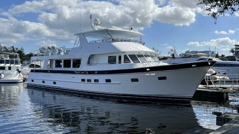 a large white boat in a harbor aboard JULIANNE Yacht for Sale