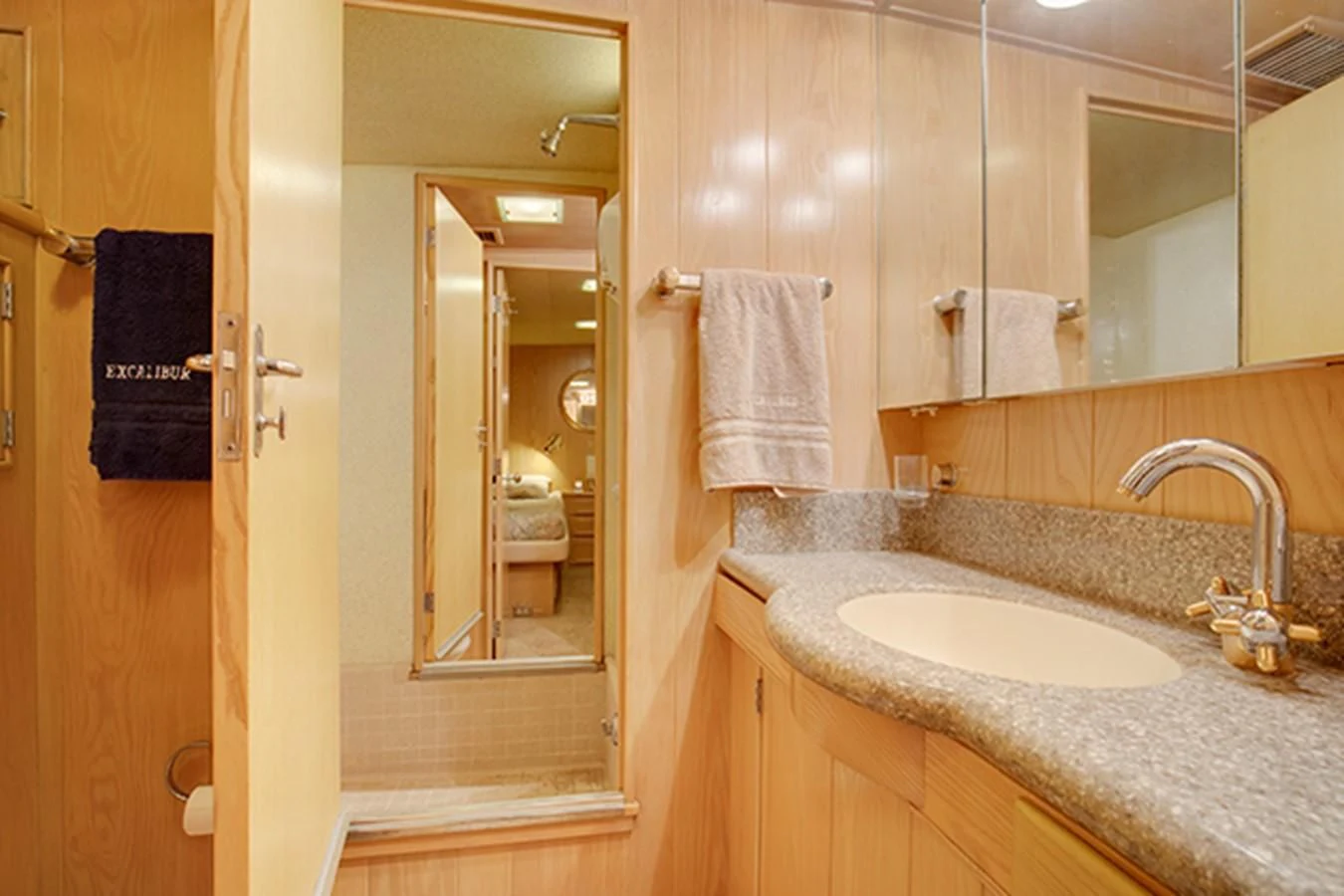 a bathroom with a sink and a mirror aboard EXCALIBUR Yacht for Sale