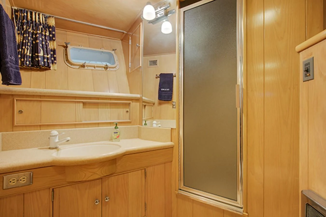 a bathroom with a sink and a mirror aboard EXCALIBUR Yacht for Sale