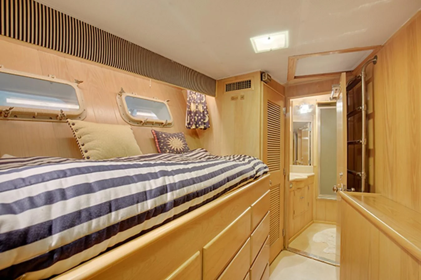a bedroom with a bed and a closet aboard EXCALIBUR Yacht for Sale