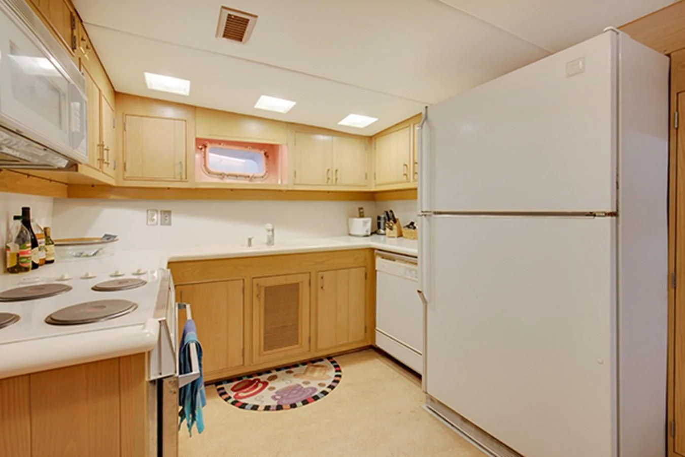 a kitchen with white appliances aboard EXCALIBUR Yacht for Sale